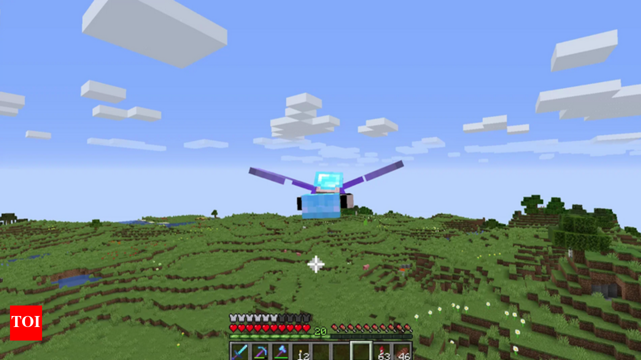 A Minecraft player gliding with Elytra above a large landscape